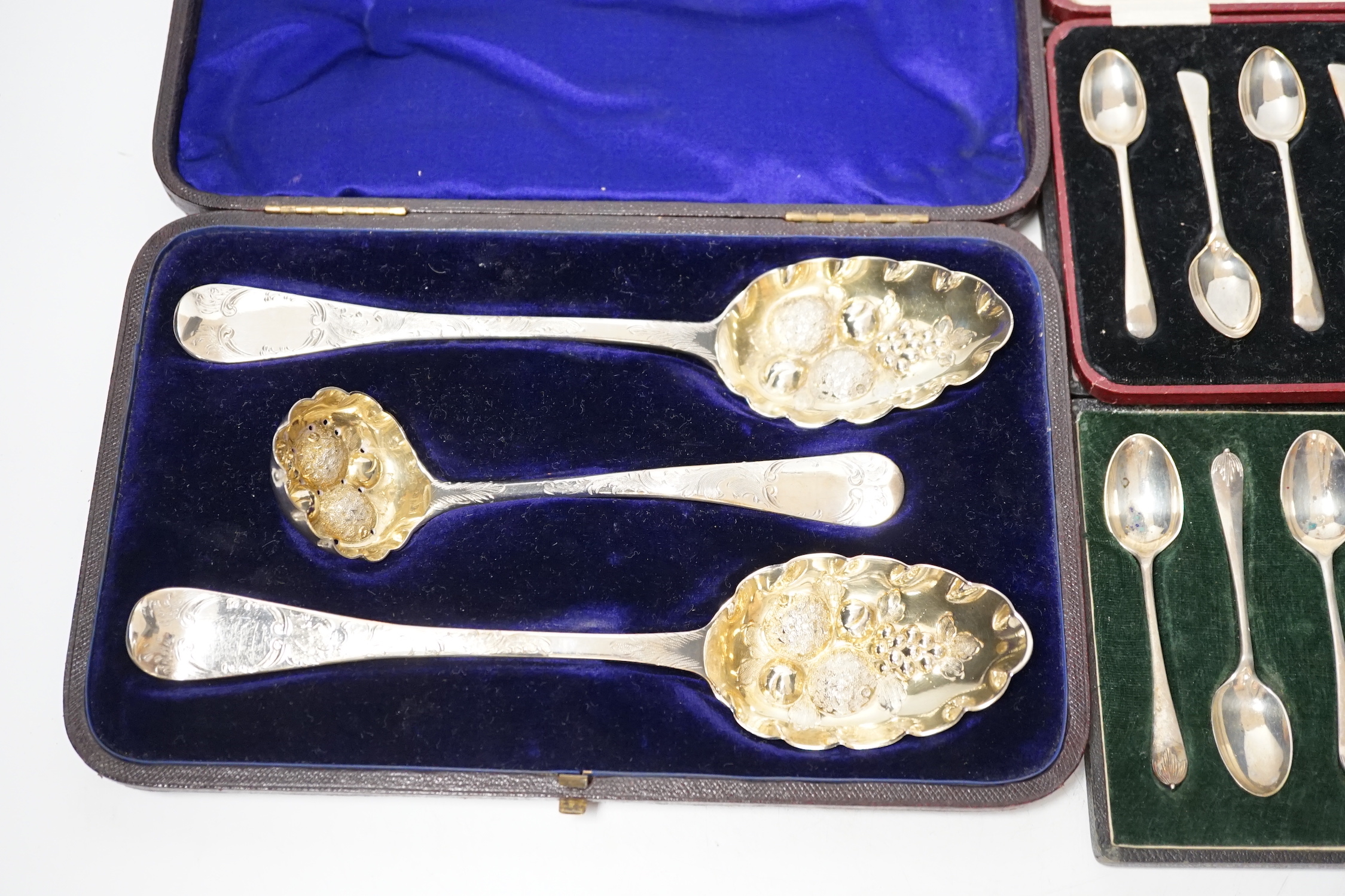 Three assorted cases of silver flatware, including two sets of six silver teaspoons and a 19th matched silver three piece serving and sifter spoon set.